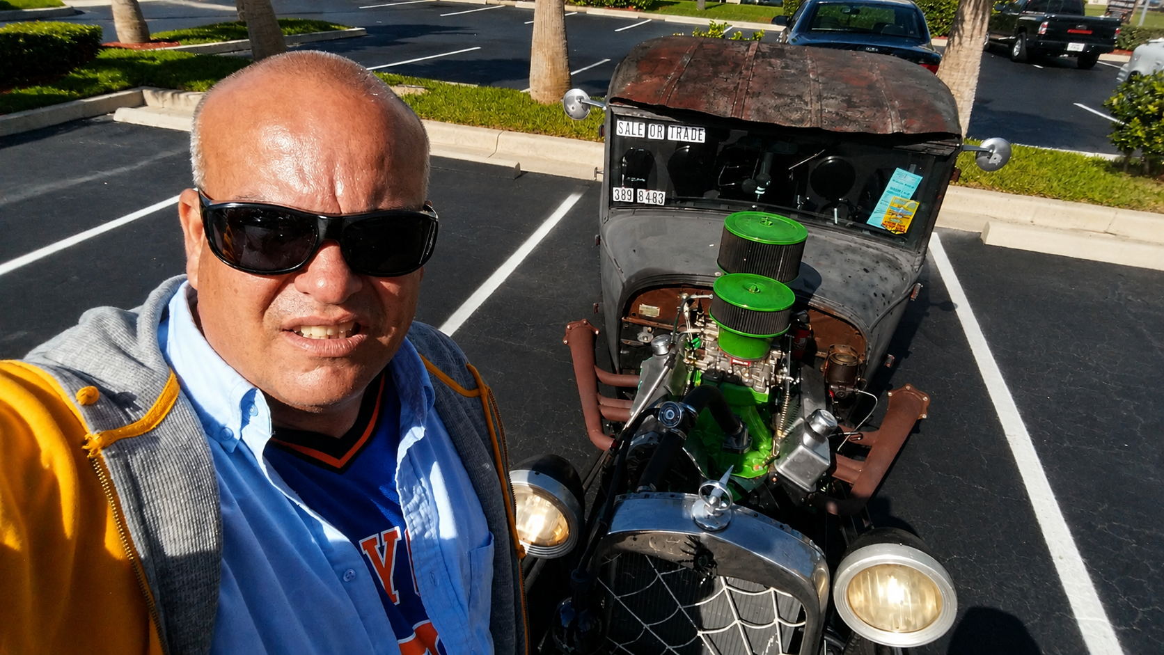 Jorge Sanchez beside a vintage car